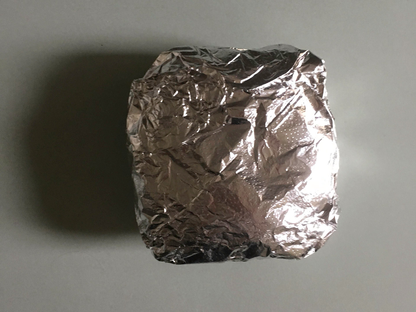 Perfectly portable, the bacon egg and cheese sandwich comes simply packaged in wax paper and tin foil