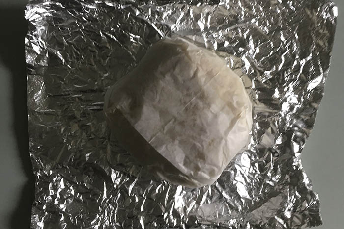 The bacon egg and cheese sandwich comes simply packaged in wax paper and tin foil